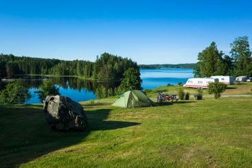 Camping in Scandinavia, Green tent on a campsite grass