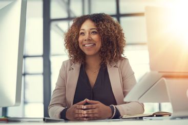 Happy, business woman and thinking with computer for...