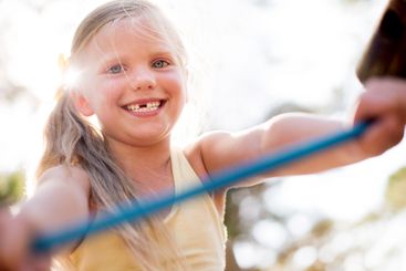 Happy girl, portrait and fun childhood with playground...