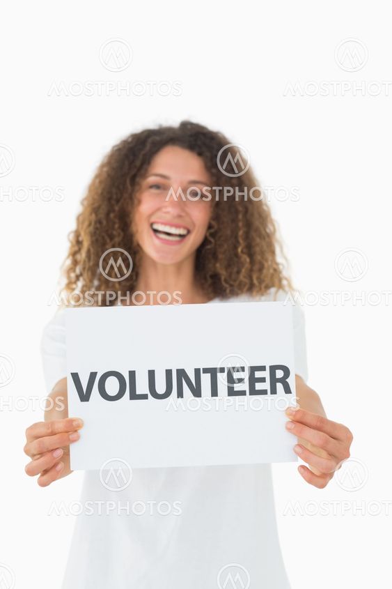 Smiling volunteer showing a poster