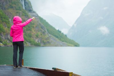 Tourist looking at mountains and fjord Norway, Scandinavia.