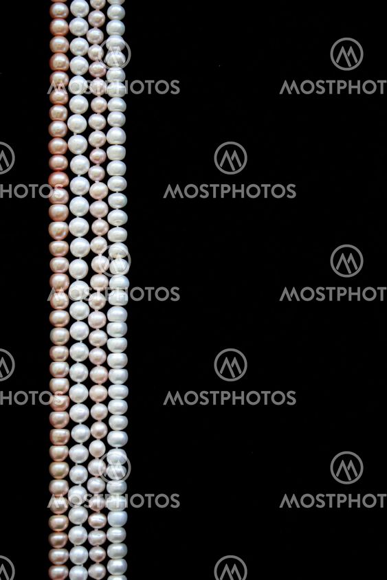 White and pink pearls on the black velvet