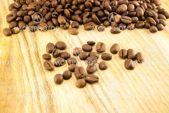 Coffee beans on vintage wooden board