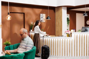 Elderly travelers wait in hotel lounge