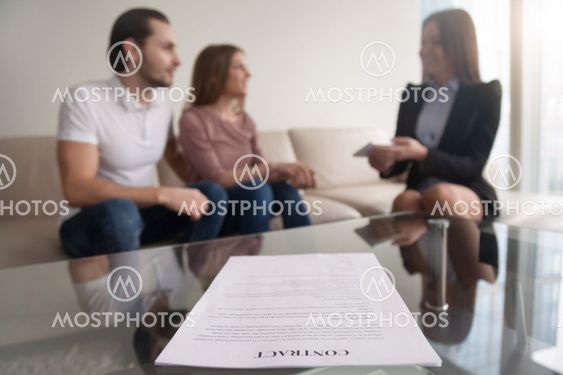 Young couple and businesswoman discussing deal, focus on contrac