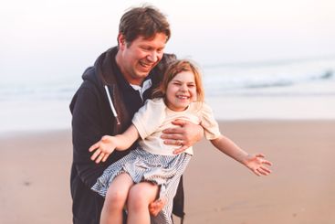 Healthy loving father and daughter playing together at...