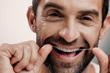 Teeth, smile and man in portrait with dental floss for...