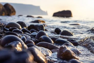Sunrise and sunset on the stone seashore. landscape in...