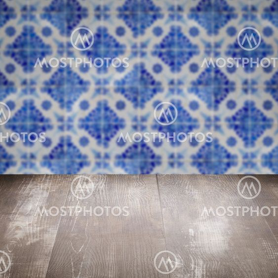 Wood table top and blur vintage ceramic tile pattern wall