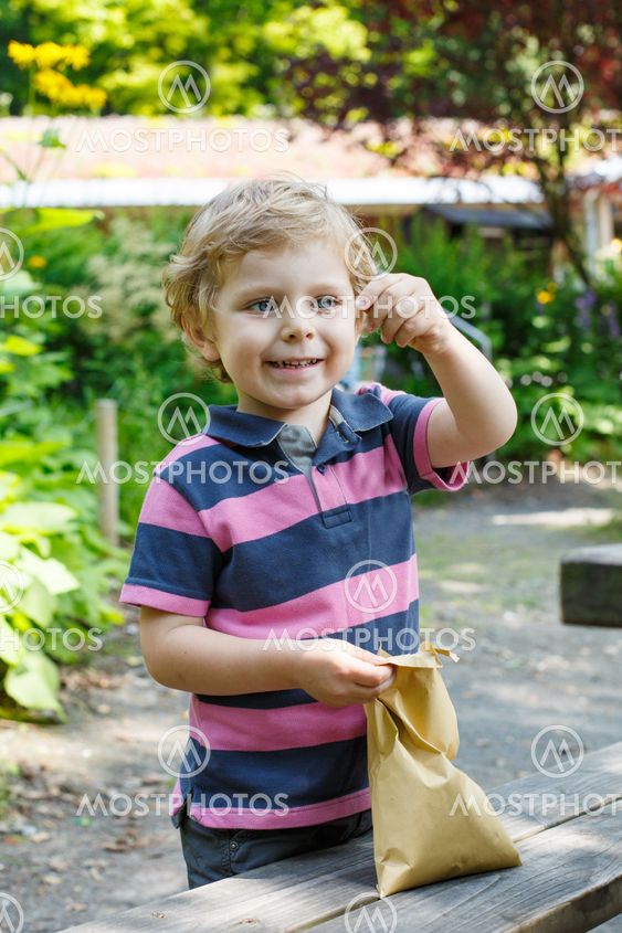 Smiling little toddler boy outdoors portrait.