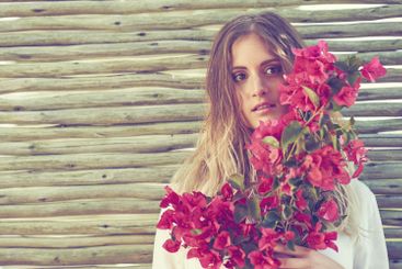 Bohemian, fashion and woman with flower bouquet outdoor...