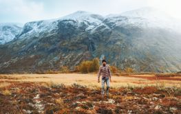 Traveler man in mountains of Norway autumn season travel