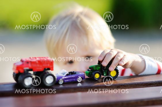 Toddler boy playing with toy cars