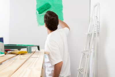 Man painting the wall with roller