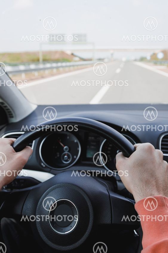 Young man driving a car, interior shot