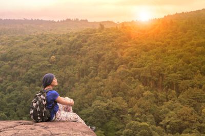 traveling woman relaxing trekking on rock cliff use for...