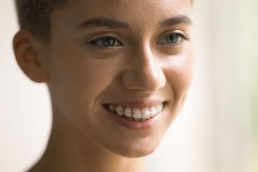 Close up cropped shot beautiful smiling millennial...