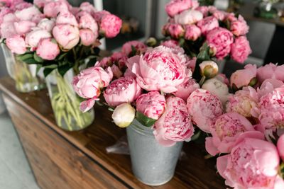The counter of the flower shop. Pink peonies in a metal...