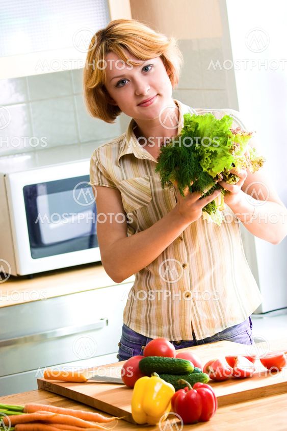 Young woman making salad