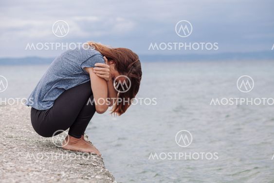 Woman alone and depressed on the bridge