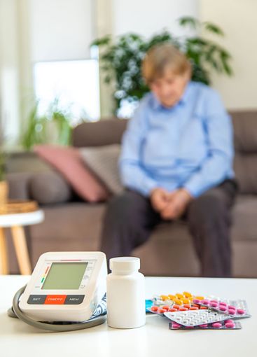 An old woman measures her blood pressure. Selective focus.