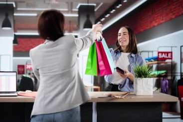 Businesswoman Checking Into Hotel with Credit Card