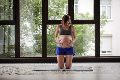 Pregnant woman dose sports on balcony