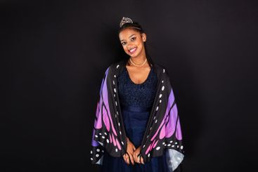 Brunette teen girl wearing butterfly wings confident and...