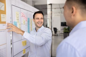 Cheerful male Hispanic project manager presenting...