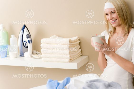 Laundry ironing - woman coffee break