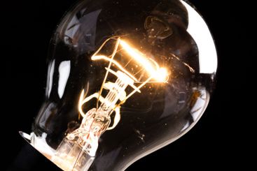 Close-up of electrical bulb on black background
