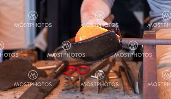 Glassblower Turning Molten Glass