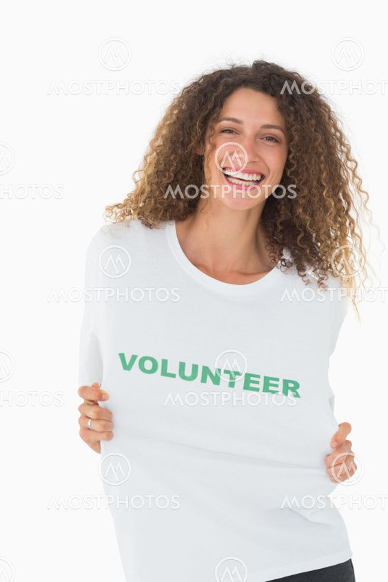 Happy volunteer showing her tshirt to camera