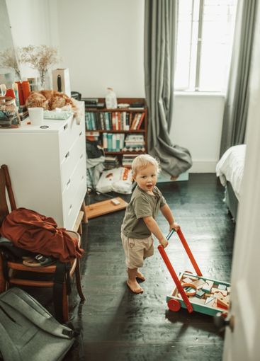 Cute, toys and boy toddler playing in his nursery for...