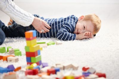 Toddler smiling tickled by mother�
