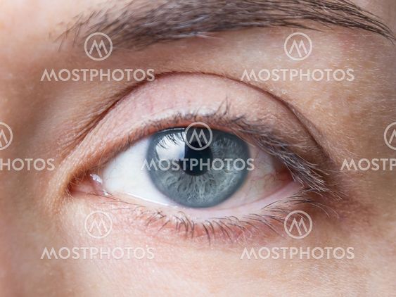 Closeup of female natural blue eye without makeup