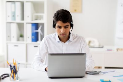 businessman with headset and laptop at office
