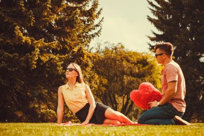 Moody girl with boyfriend in park. 