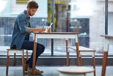 Cafe, laptop and man with notebook for writing, research...