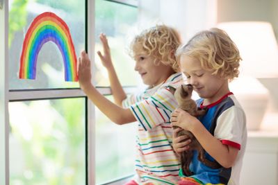 Coronavirus quarantine. Kids at window. Stay home.