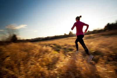 Young woman running outdoors on a lovely sunny...