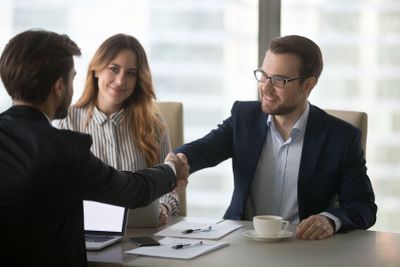 Business partners handshaking greeting at meeting in office