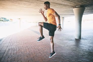 Running, jumping or black man in city for fitness,...