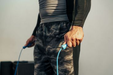 Workout session featuring a person using a jump rope in...