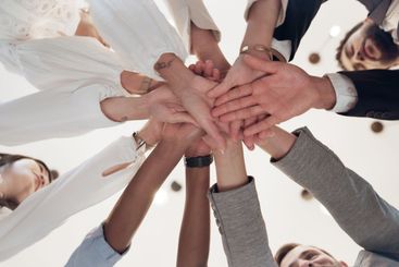 Business, people and low angle with hands together in...