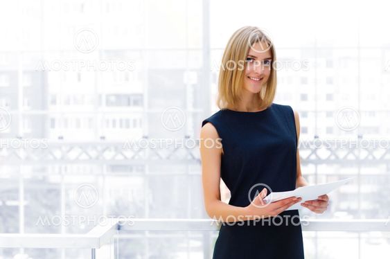 business woman holding reports and looking to the camera