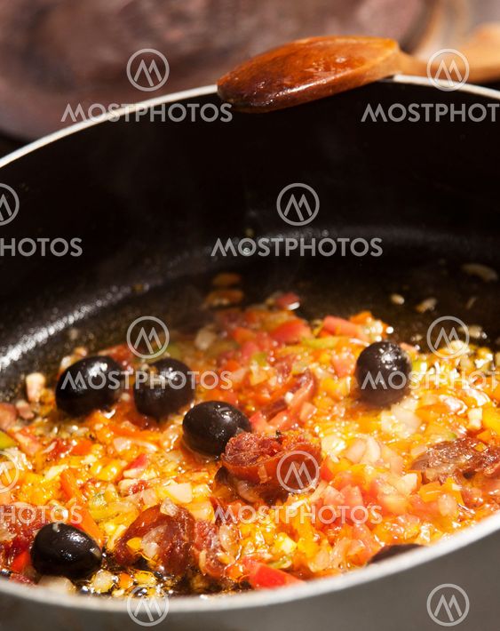 Stir-frying vegetables and sausage