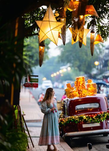 Woman on street with Christmas decorations