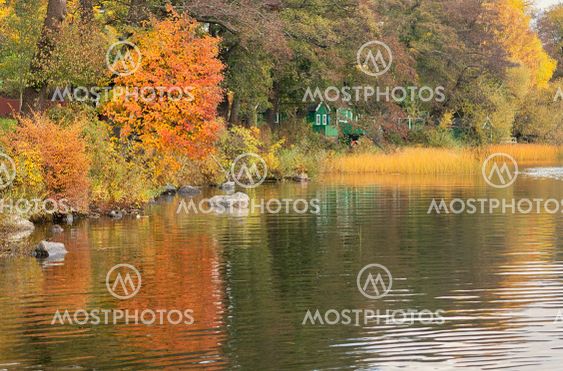 Green cottages at the canal in autumn.