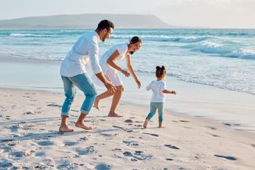 Happy family, beach or toddler playing with parents on...